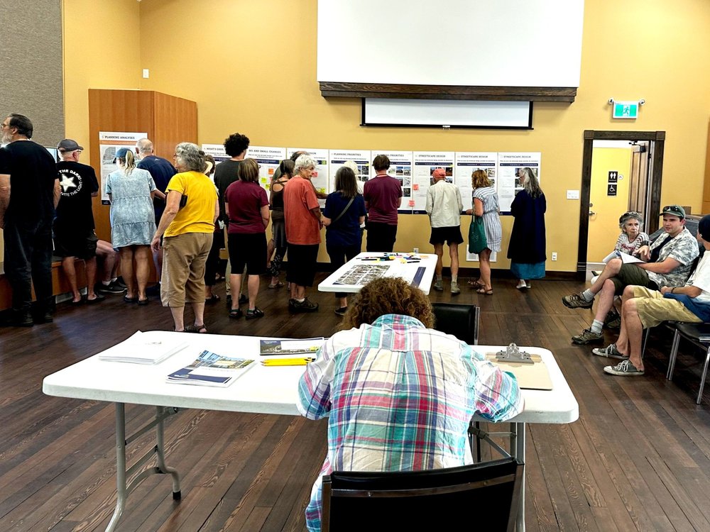 Community members reviewing planning materials at a New Denver open house